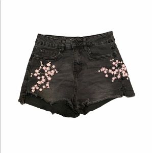 Black denim shorts with embroidered purple flowers